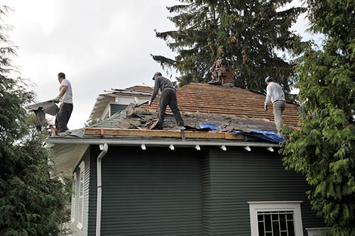 roof-repair-crew-tearing-off-and-reroofing
